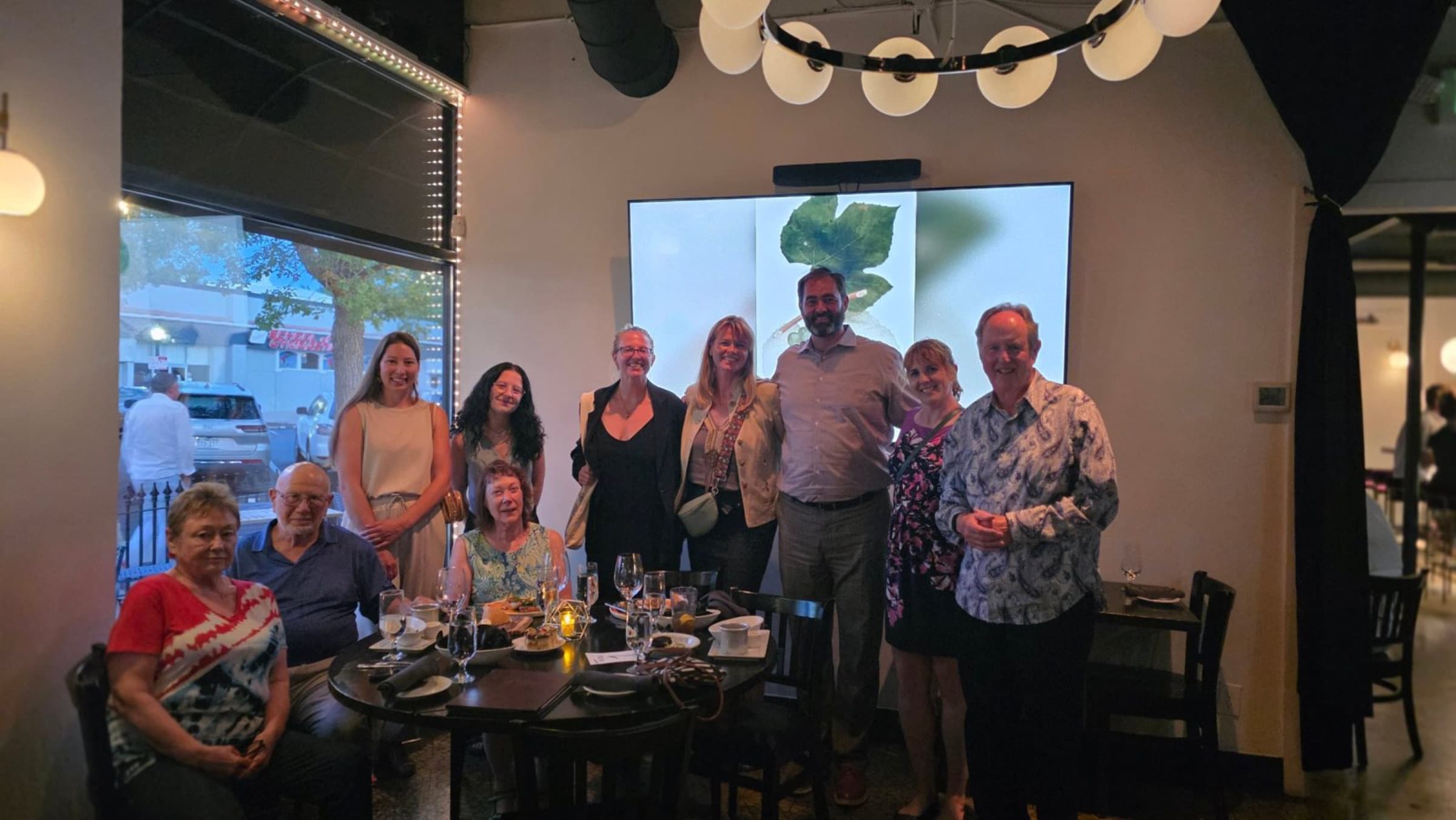 AUP alumni posing for a group photo at a restaurant in Denver