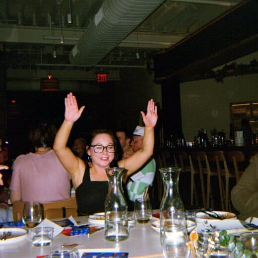 A guest raising her hands in celebration