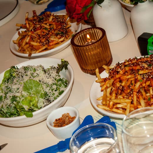 Fries and a green salad on the table