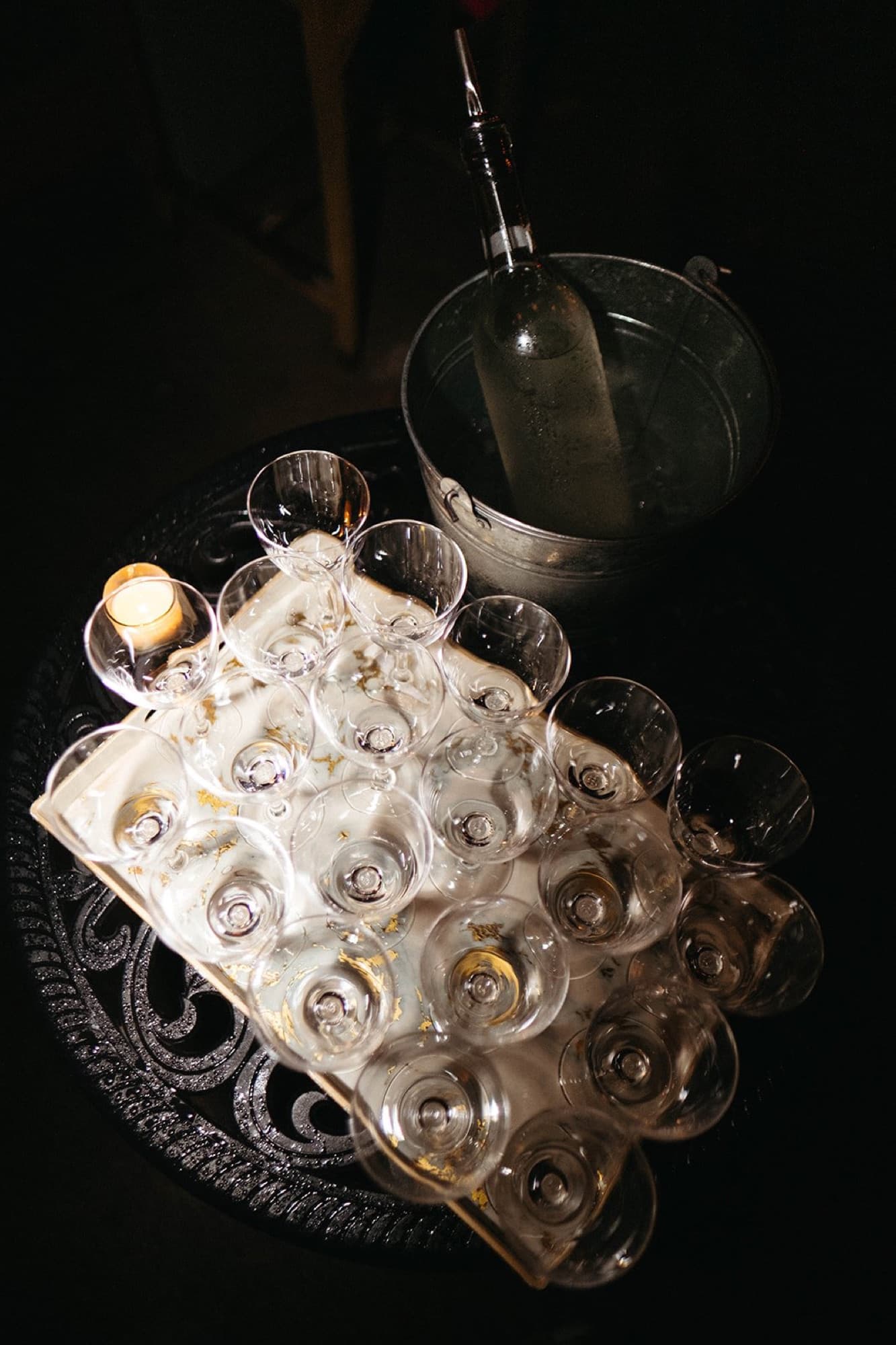 A tray of empty glasses beside an ice bucket